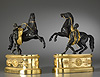 A fine pair of Empire gilt and patinated bronze statuettes based on models of the Marly Horses by Guillaume I Coustou